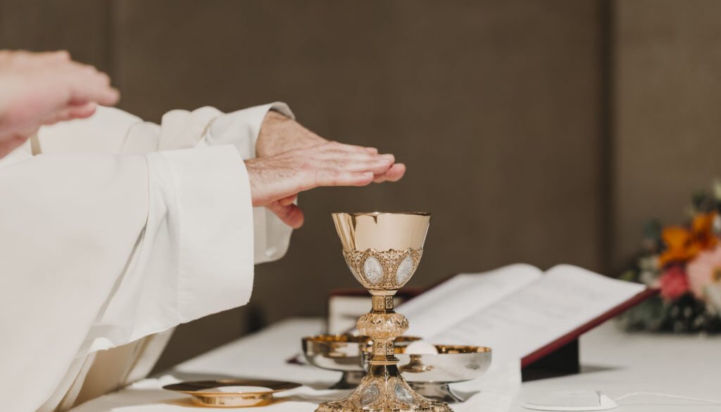 unrecognizable Priest holding the goblet during a wedding ceremony nuptial mass. Religion concept