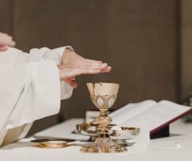 unrecognizable Priest holding the goblet during a wedding ceremony nuptial mass. Religion concept