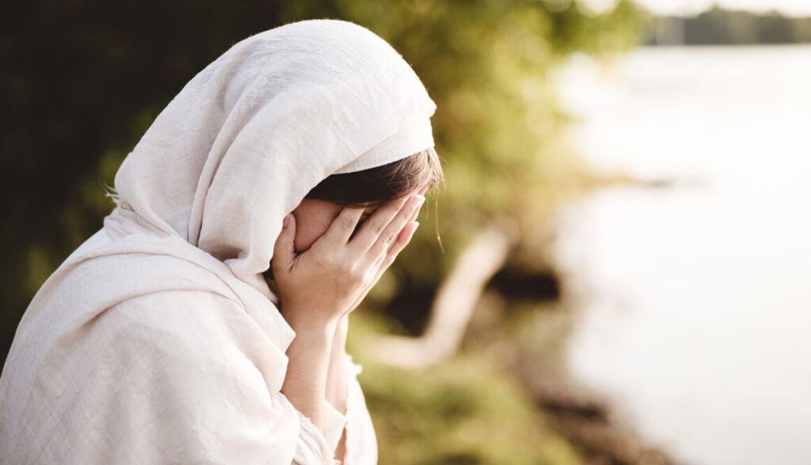 Closeup shot of a female wearing biblical robe crying - concept confessing sins