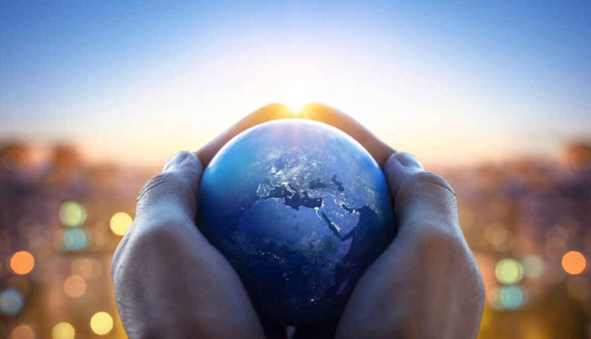 Planet Earth in the hands of a man against the background of the