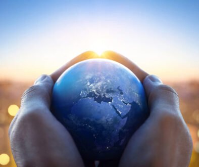 Planet Earth in the hands of a man against the background of the