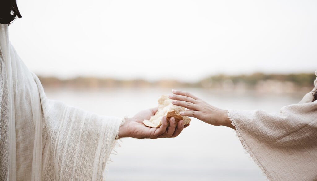 Biblical scene - of Jesus Christ giving bread to a female with a blurred background
